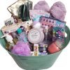 Luxury spa gift basket for women featuring blankets slippers and bath bombs