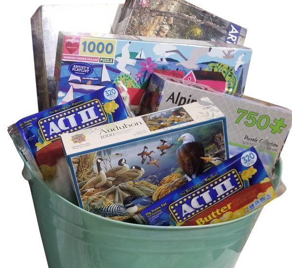 A curated family puzzle night gift box with games and snacks for a family night in.