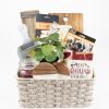 Personalized housewarming gift basket featuring custom laser engraved wooden cutting board and coasters