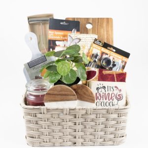 Personalized housewarming gift basket featuring custom laser engraved wooden cutting board and coasters