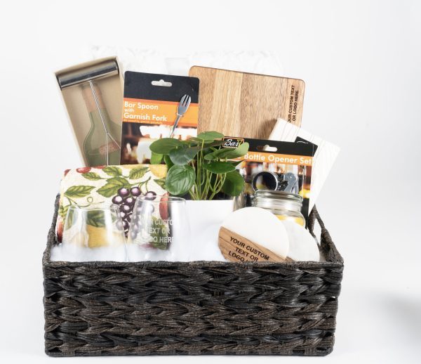 Personalized housewarming gift basket with custom engraved wood cutting board, two custom glasses, 2 engraved coasters, and premium throw blanket.