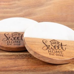 Pair of round marble and wood coasters engraved with Home Sweet Home for realtor closing gifts.