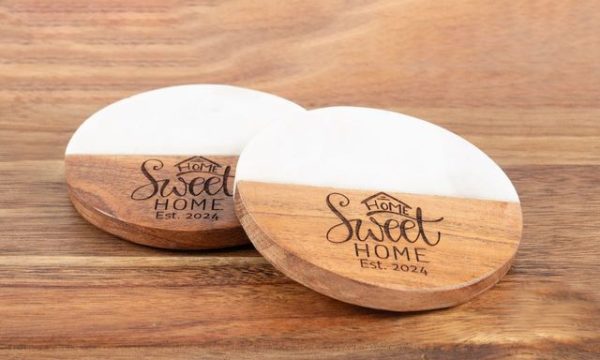 Pair of round marble and wood coasters engraved with Home Sweet Home for realtor closing gifts.