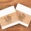 Pair of square marble and wood coasters engraved with Home Sweet Home for realtor closing gifts.