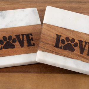Set of two square white marble and wood pet coasters with laser engraved LOVE paw print design.