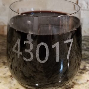 Pair of personalized rocks glasses laser engraved with custom zip code for housewarming gift.