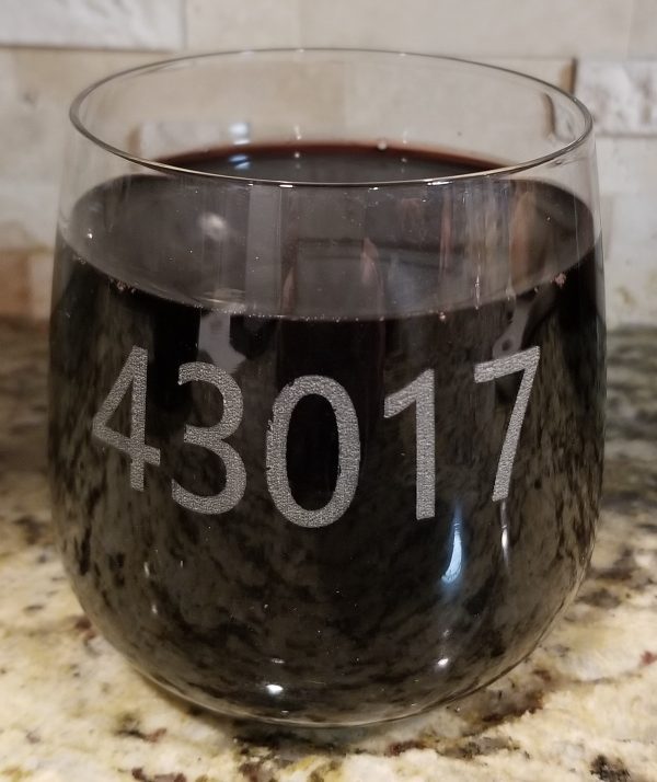 Pair of personalized rocks glasses laser engraved with custom zip code for housewarming gift.