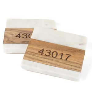 Personalized marble and wood square coasters engraved with custom zip code