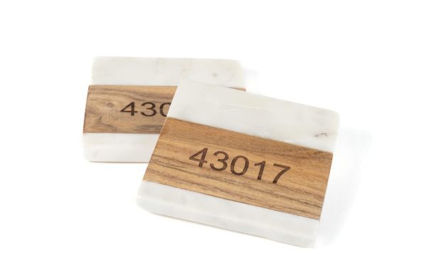Personalized marble and wood square coasters engraved with custom zip code