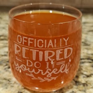 Etched rocks glass with "Officially Retired" design for retirement gift.