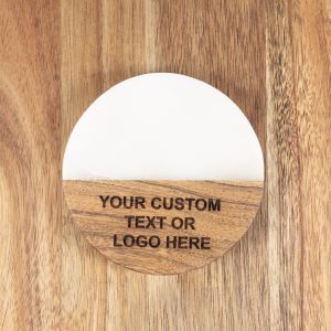 Pair of personalized round white marble and wood coasters with custom laser-engraved company logo.