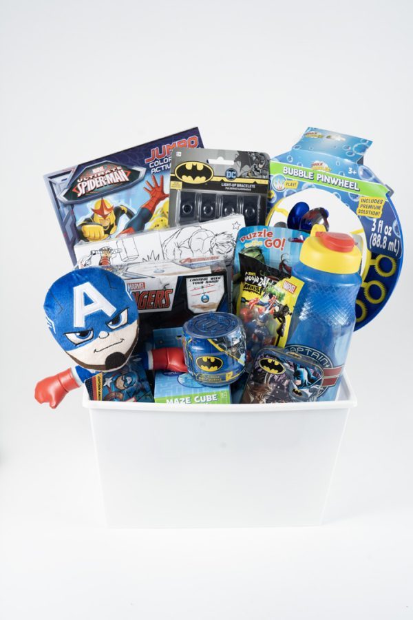 Marvel and DC superhero gift basket for kids featuring plush toys and puzzles