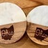 Pair of 4-inch round State of Ohio coasters made of white marble and natural wood.