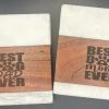 Pair of laser engraved marble and wood Dog Mom and Dog Dad coasters for pet parents.