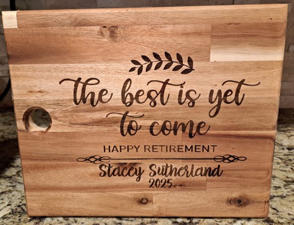 Personalized retirement cutting board made of acacia wood with custom name engraving