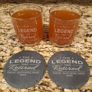 Personalized retirement whiskey gift set with two engraved glasses and slate coasters for bourbon lovers and whiskey lovers.