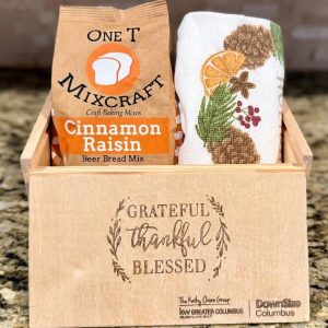 Bulk corporate appreciation gift boxes 25 pack with laser engraved custom business logo on wooden slide box holding gourmet bread mix and kitchen towel.