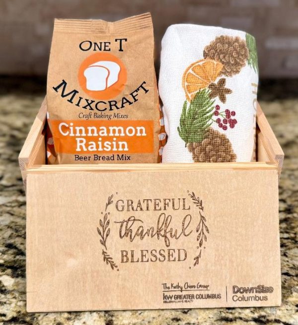 Bulk corporate appreciation gift boxes 25 pack with laser engraved custom business logo on wooden slide box holding gourmet bread mix and kitchen towel.