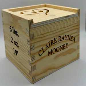 Personalized baby keepsake box made of wood with custom engraved birth information for a new baby gift.