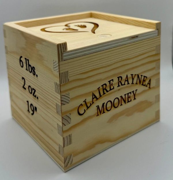 Personalized baby keepsake box made of wood with custom engraved birth information for a new baby gift.
