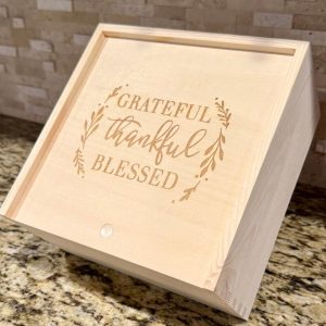 Custom corporate gift boxes made of wood with laser engraved company logo on the sliding lid.