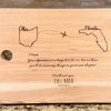 Personalized solid hickory cutting board with laser engraved states for relocation gift.