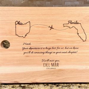 Personalized solid hickory cutting board with laser engraved states for relocation gift.