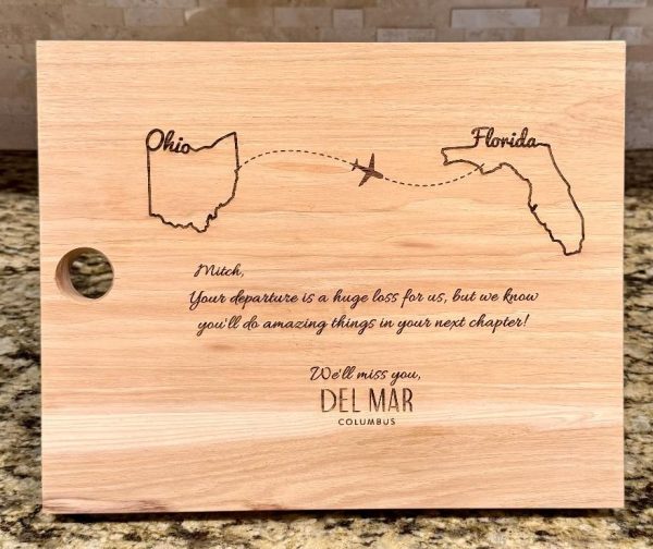 Personalized solid hickory cutting board with laser engraved states for relocation gift.