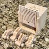 Personalized wooden kids garage with engraved family names for toy car storage.