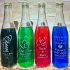 Personalized 12oz glass wedding favor bottles with custom logo engraving and gold lids.