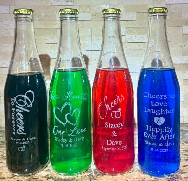 Personalized 12oz glass wedding favor bottles with custom logo engraving and gold lids.
