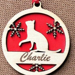 Personalized wood cat ornament with custom engraved name hanging on a Christmas tree