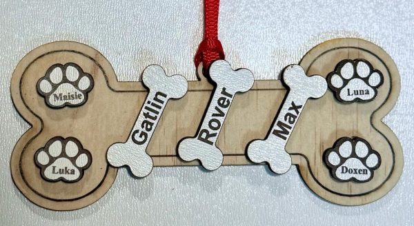 Personalized dog bone ornament laser engraved with multiple pet names and pawprints from Ohio Basket Chic