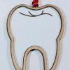 Custom dental staff gifts showing a laser engraved wood tooth ornament with personalized practice logo.