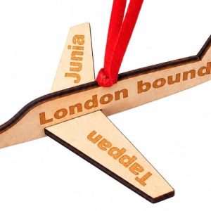 Personalized wooden airplane ornament with custom text engraved on the wings and body