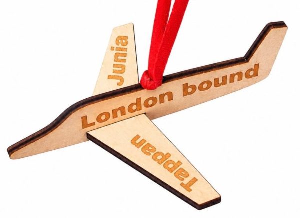 Personalized wooden airplane ornament with custom text engraved on the wings and body